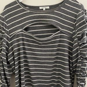 Peek a boo knit top with ruching in the long sleeves.